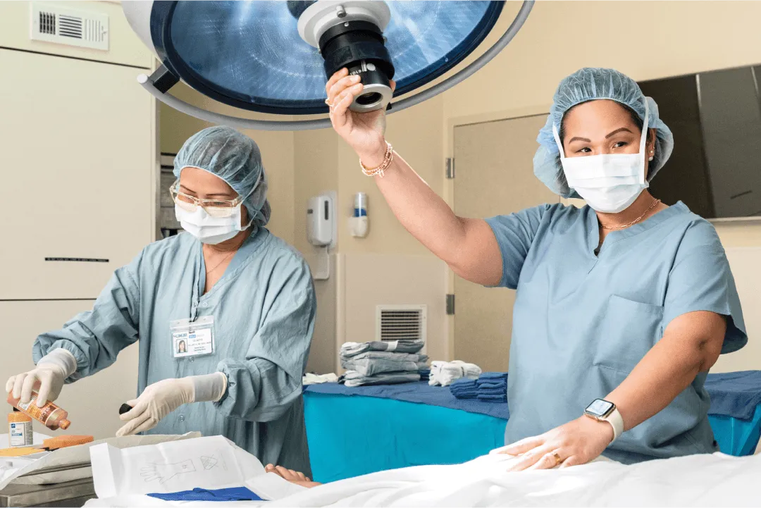 Two UCLA Health surgical clinicians wearing masks in an operating room